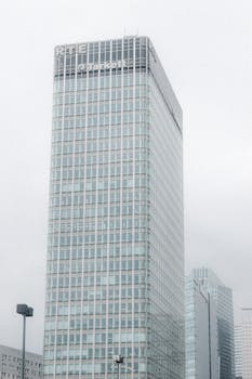 Majestic modern skyscraper with glass facade in an urban city setting.