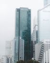 现代城市的天际线上，玻璃摩天大楼在多云的天空下高耸