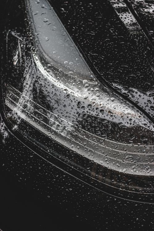 Free Black and white of small round transparent drops on big headlight of black modern car in daylight Stock Photo
