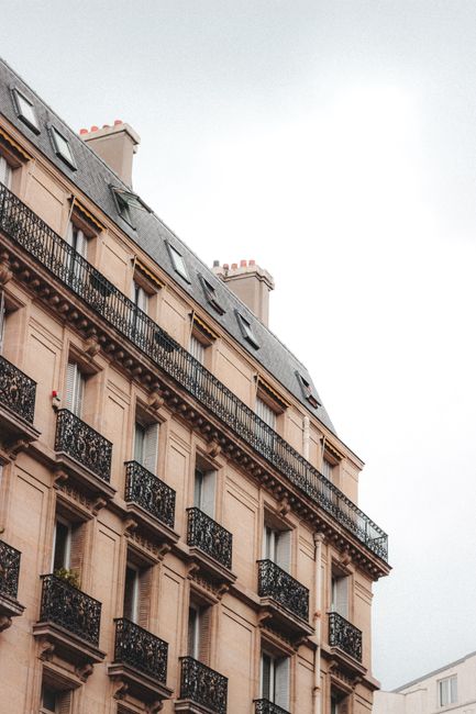 Low angle of contemporary building with balconies made by old style located in residential district of big city