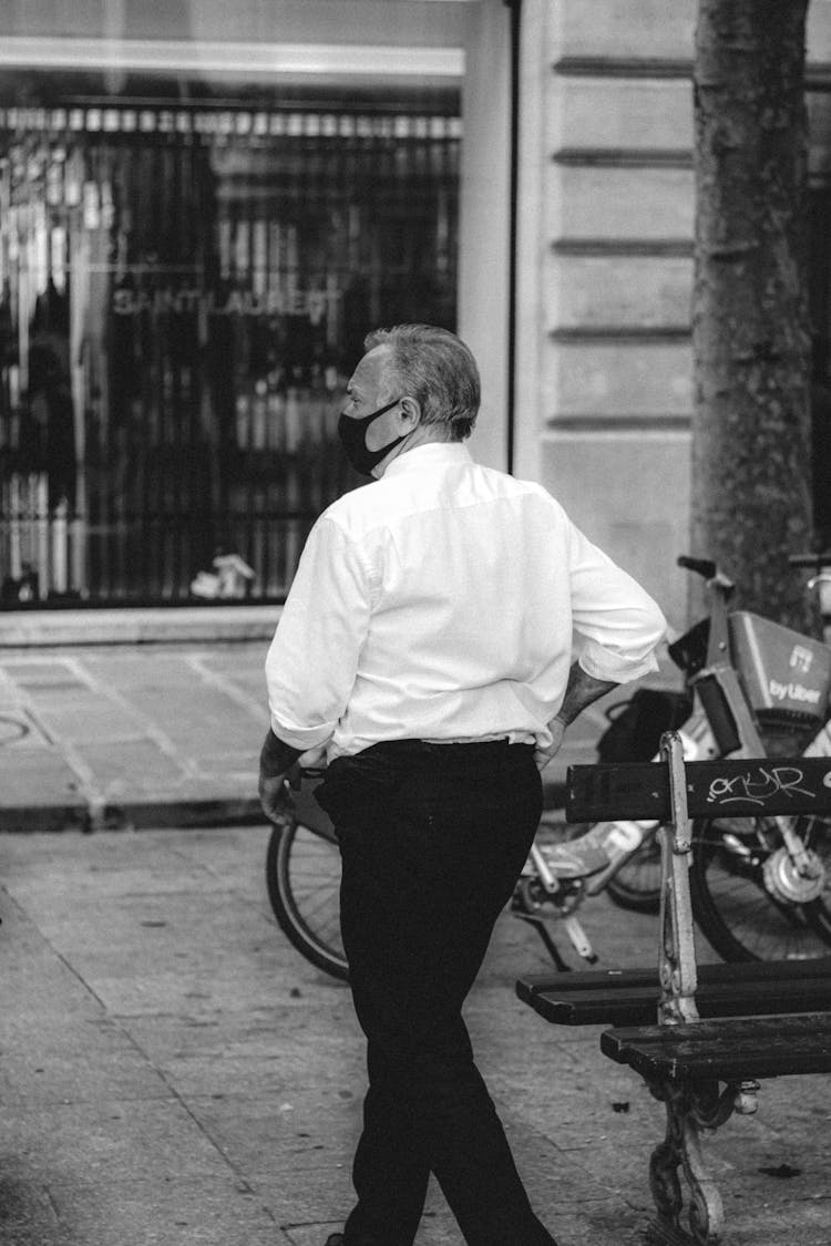 Senior Man In Suit And Mask Walking On Street