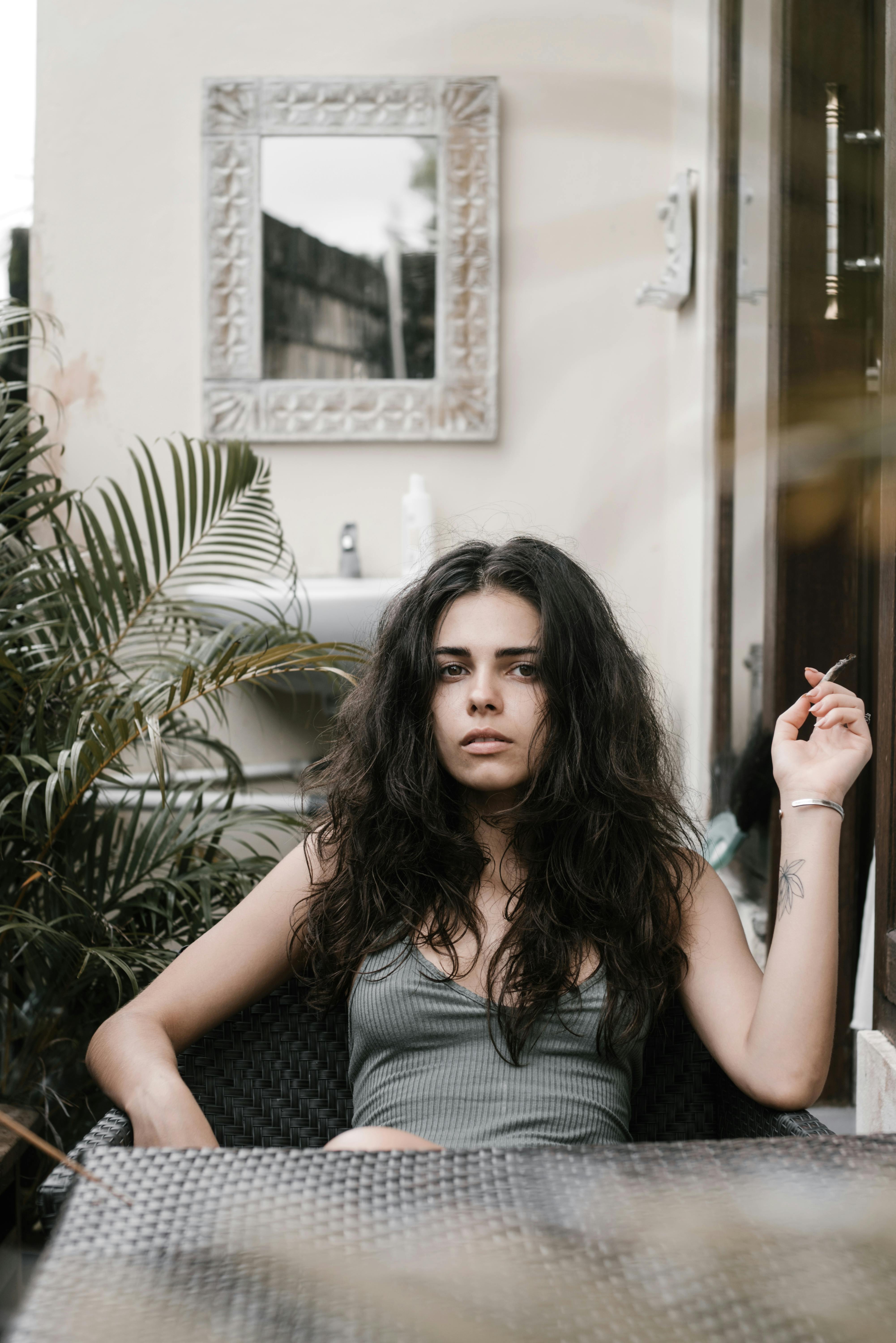 young woman relaxing with cigarette during summer holidays