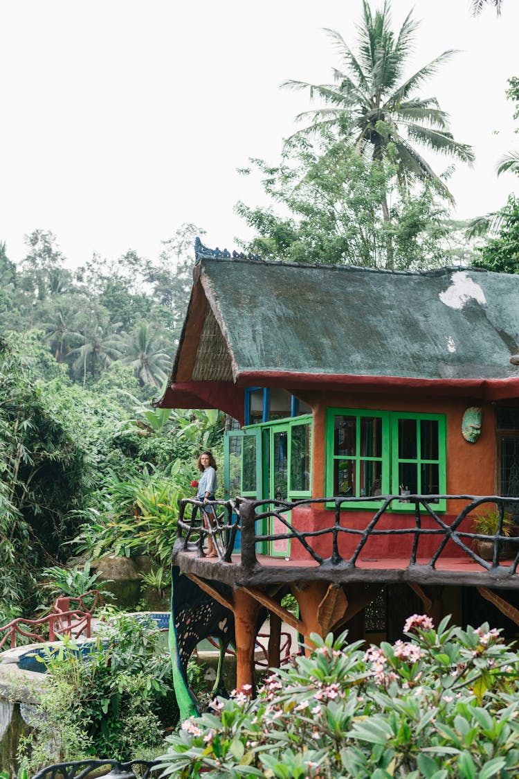 Woman On Rural House Terrace In Tropical Rainforest