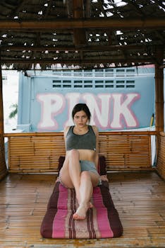 Woman lounging in a tropical bamboo gazebo, enjoying a serene moment.