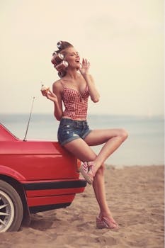 A playful retro scene featuring a woman with vintage style on a beach, leaning against a red classic car.