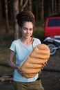 Woman Holding a Large Loaf of Bread