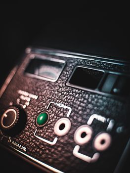 A detailed close-up of vintage audio equipment showcasing manual controls and a textured surface.