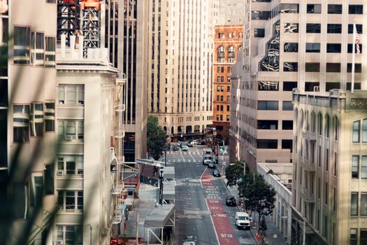 A bustling urban street surrounded by modern high-rise buildings during the day.