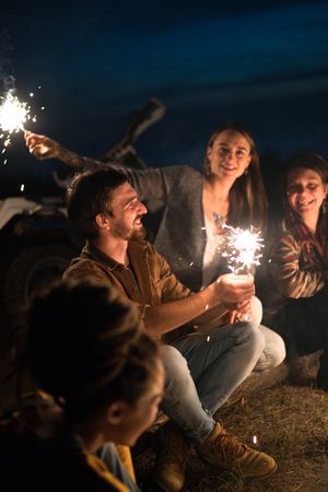 Friends sitting outdoors at night, photo by ArtHouse Studio on Pexels