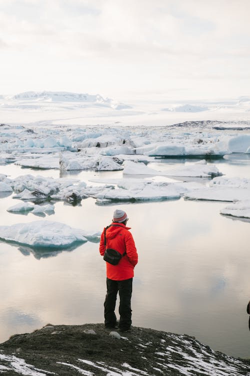 A Person Standing while Looking at the Glacier