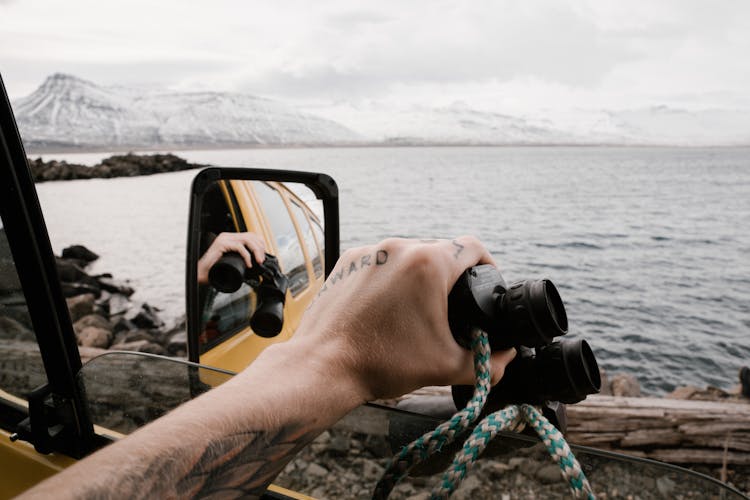 Person Holding Binoculars