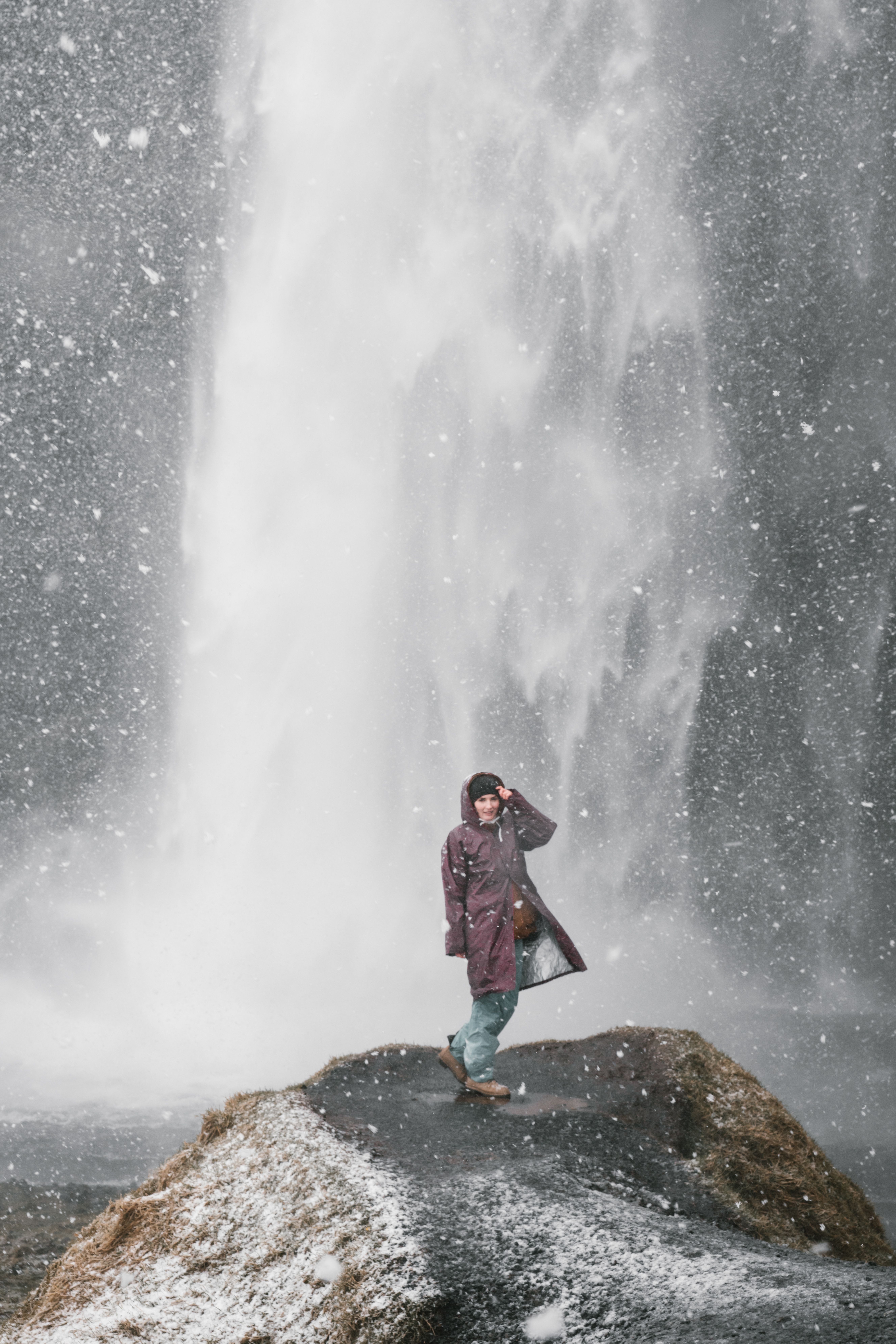 Portrait of a Woman Standing in Front of a Waterfall · Free Stock Photo