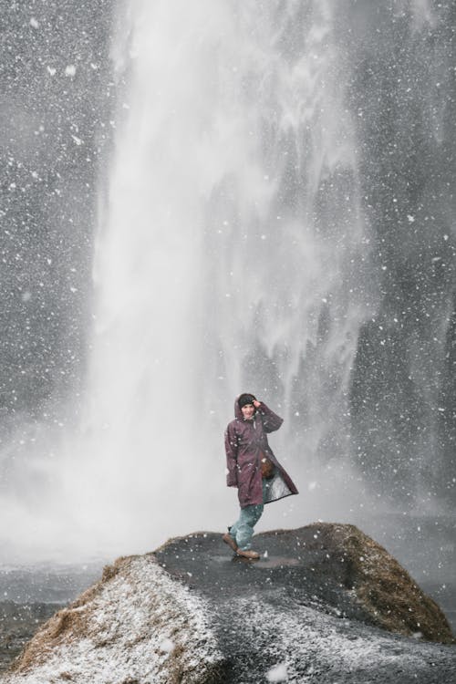 Portrait of a Woman Standing in Front of a Waterfall