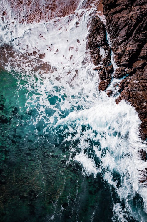 Aerial Photography of Ocean Waves Crashing the Shore