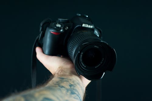 Free Professional photographer with modern photo camera Stock Photo