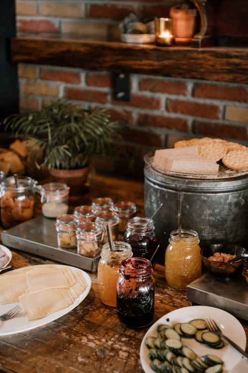Free An inviting rustic breakfast buffet setup featuring various jams and bread on a wooden table. Stock Photo