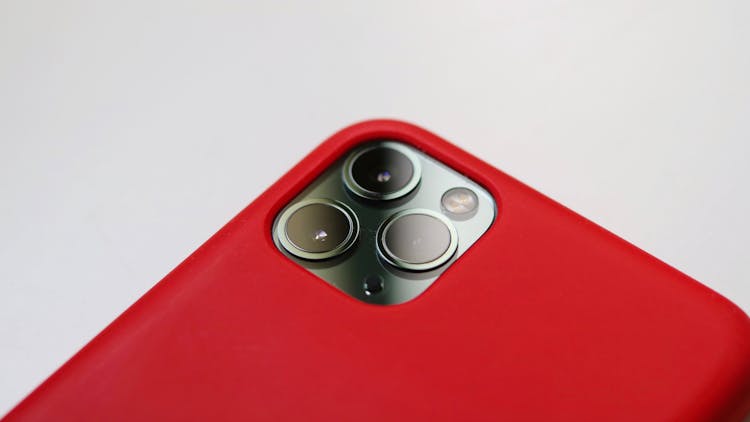 Camera Of An Iphone With Red Case In Close-up Photography