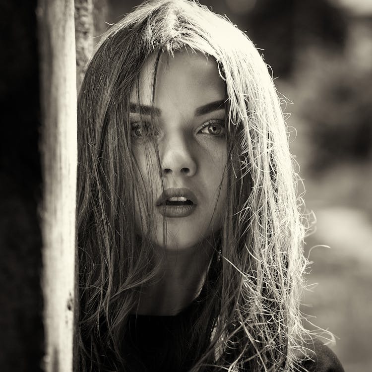 Surprised Young Woman In Park On Sunny Day