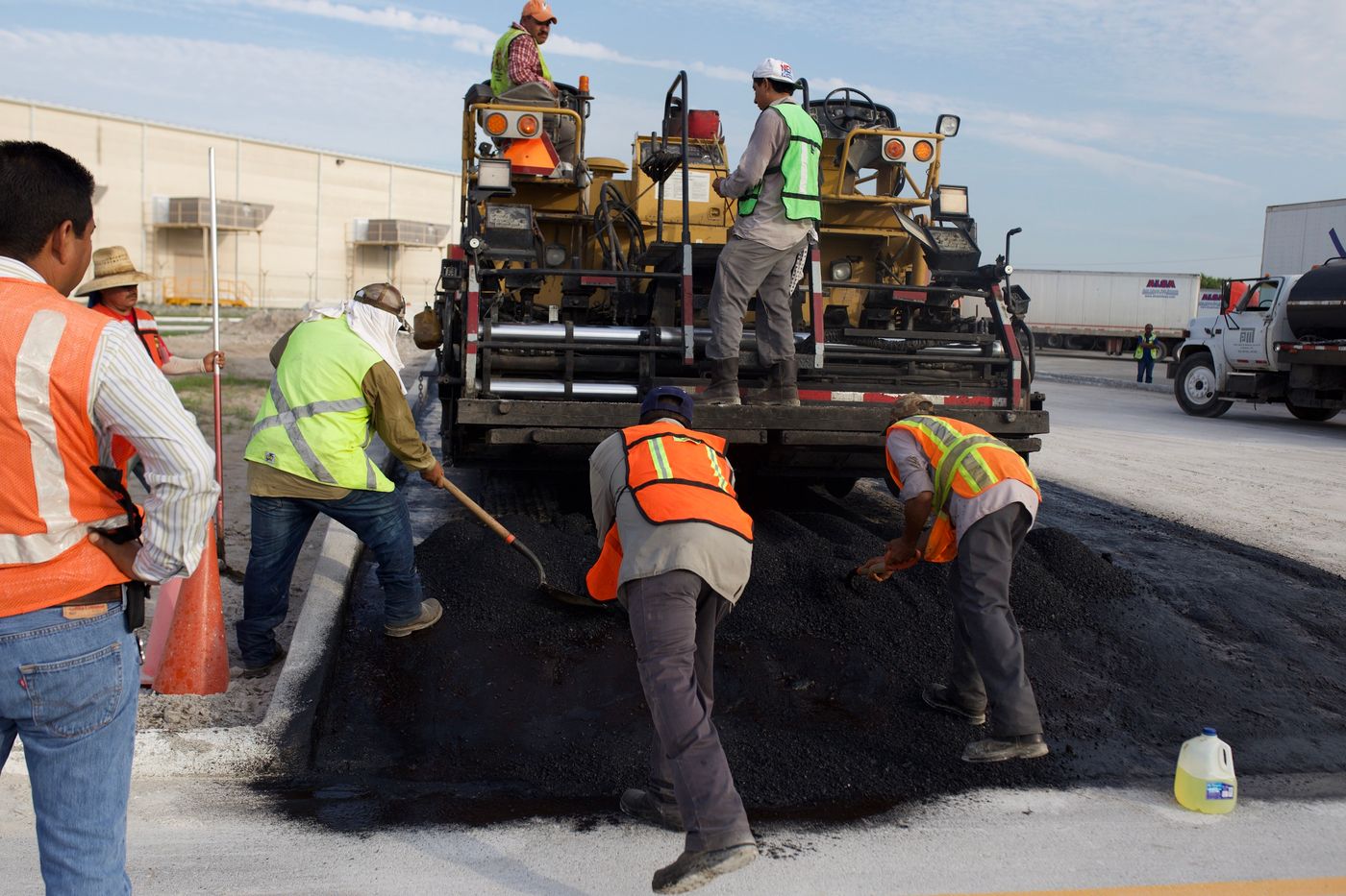 Hot mix asphalt paving crew placing asphalt