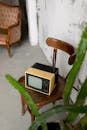 Retro TV placed on chair in room with vintage furniture