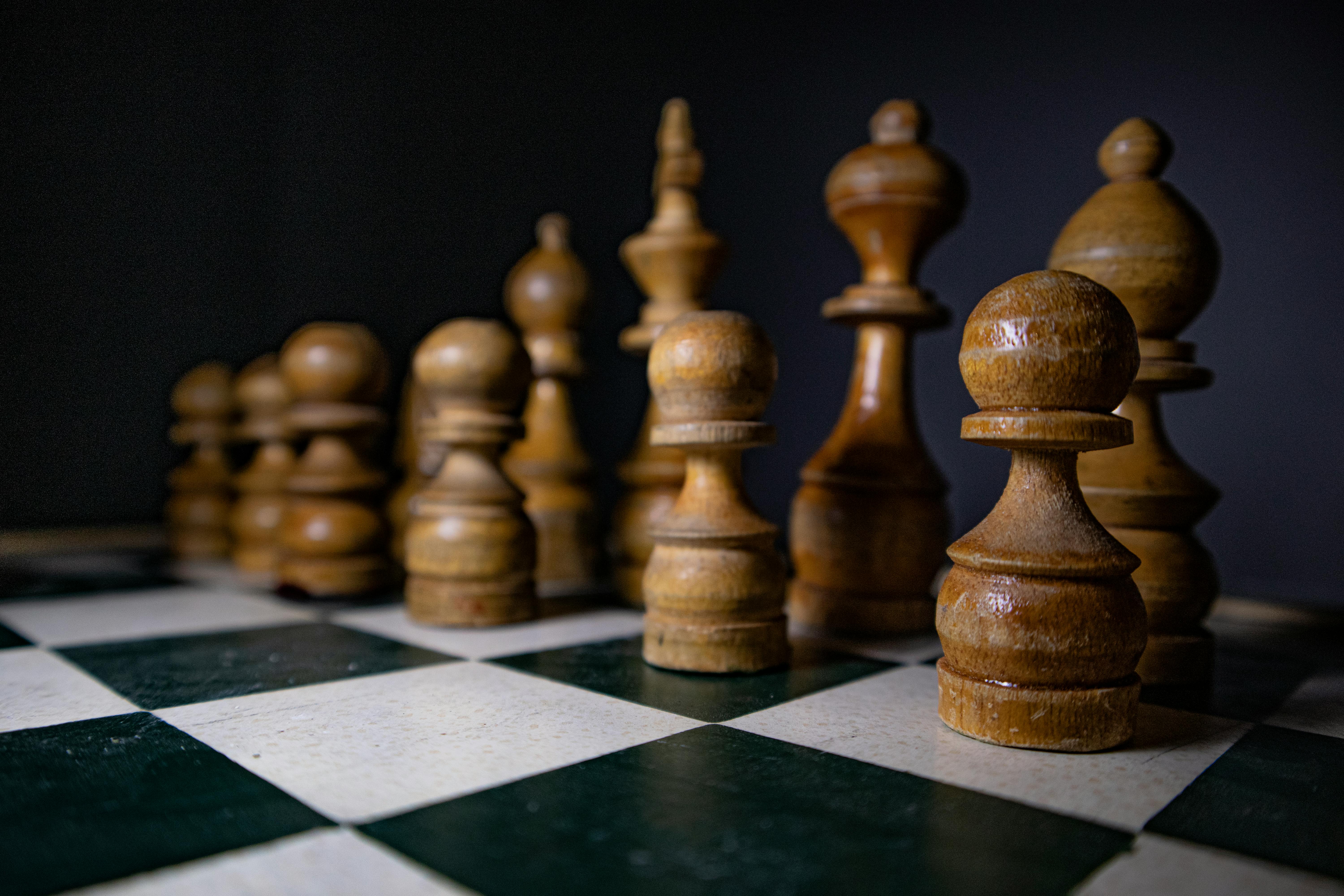 Wooden Chess Pieces on a Chess Board  Free Stock Photo