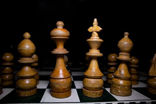 Free Strategic arrangement of wooden chess pieces on a chessboard, highlighting strategy and focus. Stock Photo