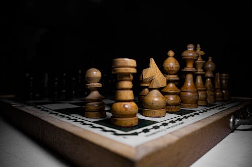 Wooden Chess Pieces on a Chess Board