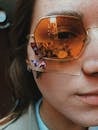 Woman in sunglasses and plaster with flowers on face