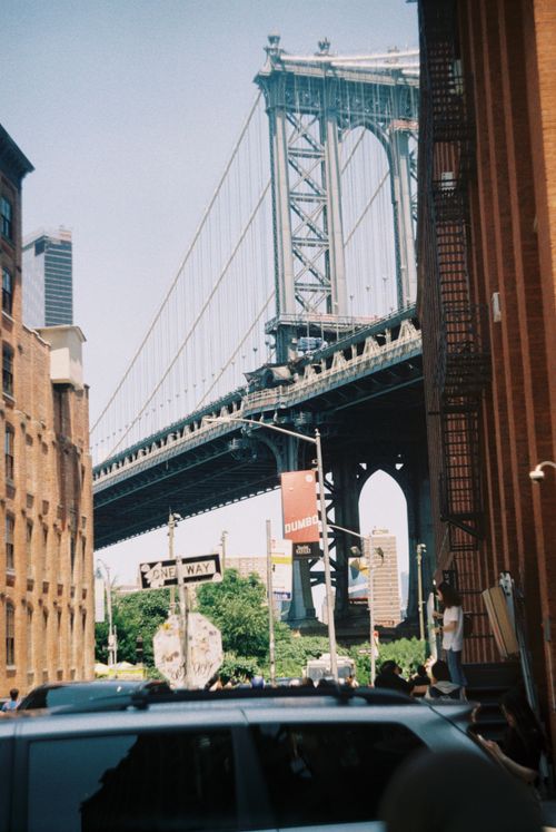 Free View of the Manhattan Bridge framed by Brooklyn streets, capturing urban essence. Stock Photo