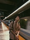 Young man waiting for train on platform