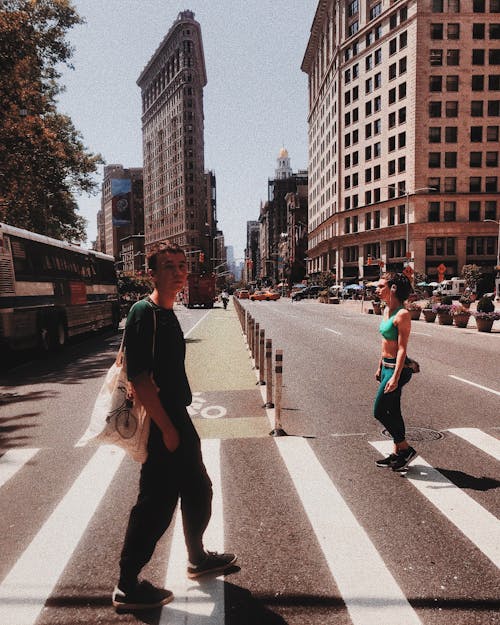 People crossing road on pedestrian crossing in modern city