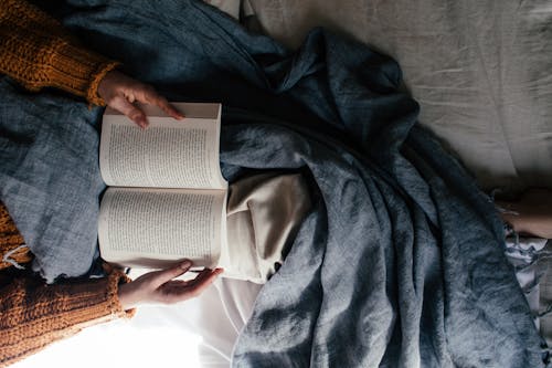 Free Lying in Bed with Book Stock Photo