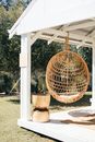 Brown Wicker Basket on White Wooden Gazebo