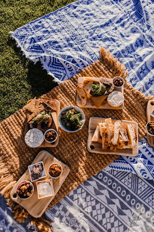 Free Bread and snacks on blanket in meadow Stock Photo