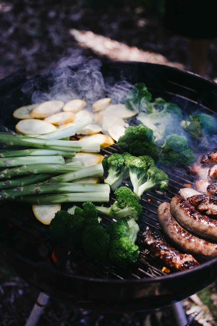 Vegetables And Sausages On Grill In Daytime