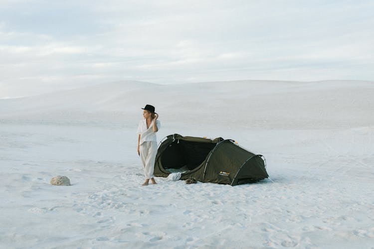 Tourist Next To Tent In Desert In Daytime