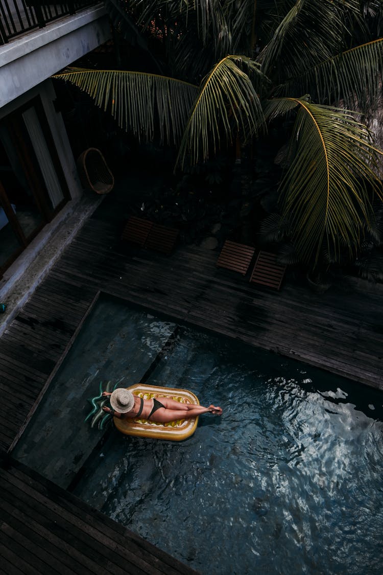 Relaxed Woman On Air Mattress In Pool