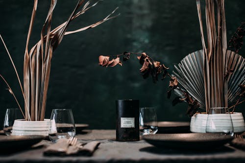 Free Banquet table with various tableware and dry plants in vases in stylish cafe Stock Photo