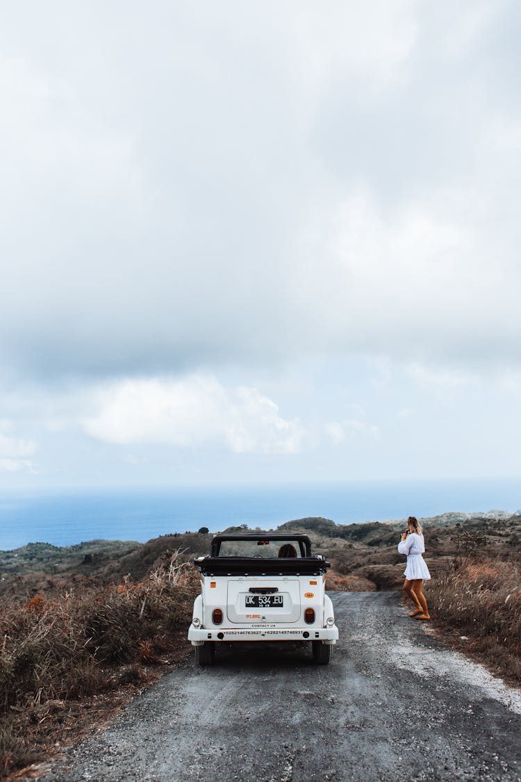 Anonymous Woman Near Car On Coast