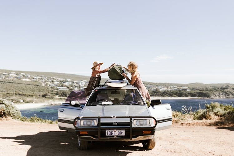 Happy Women Near Car Against Sea