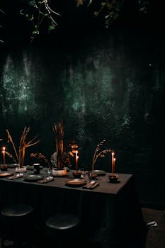 Creative interior of cafe with burning candles and dried plants on festive table