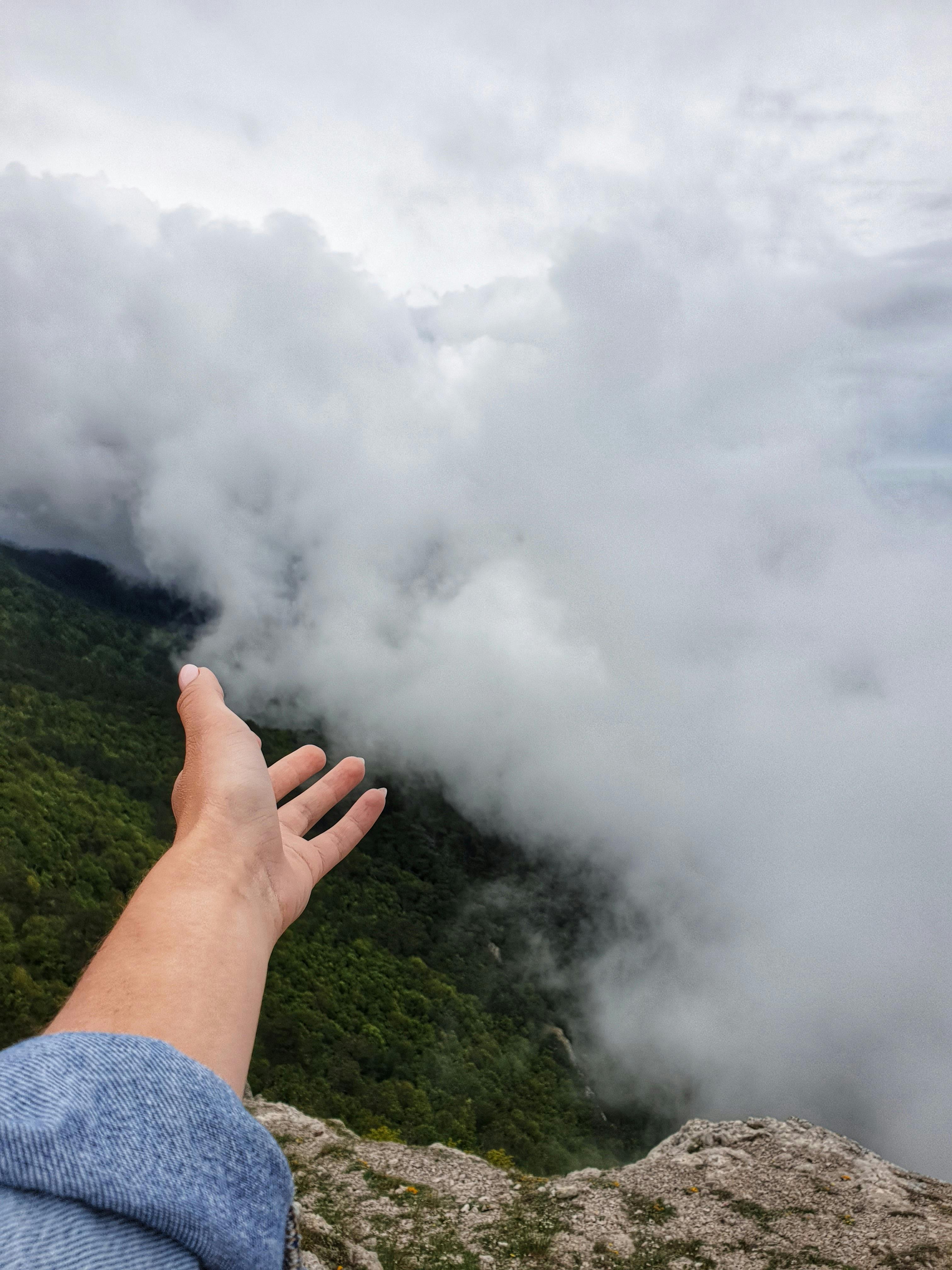 A person relaxing while soaking their feet in a white basin filled with water and Epsom salt.