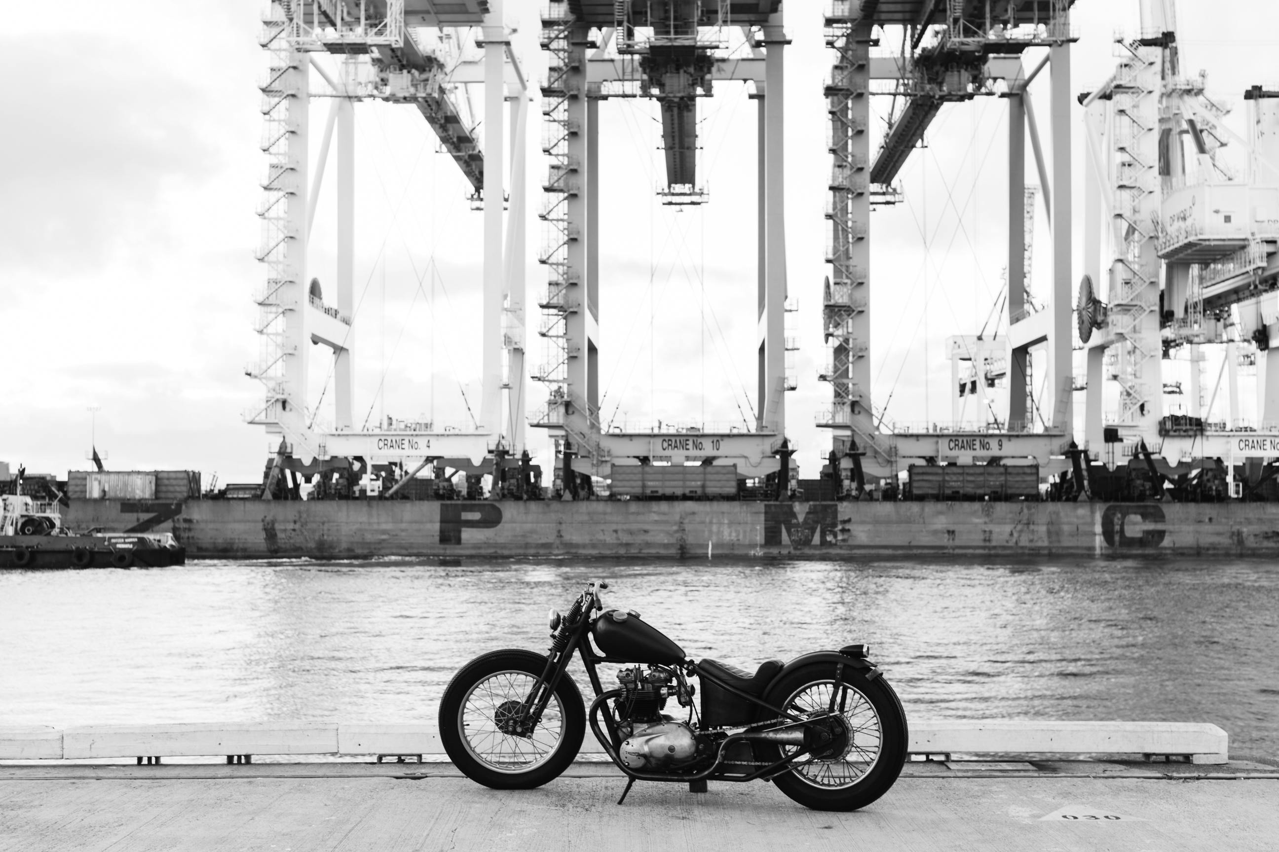 vintage motorbike on embankment of river