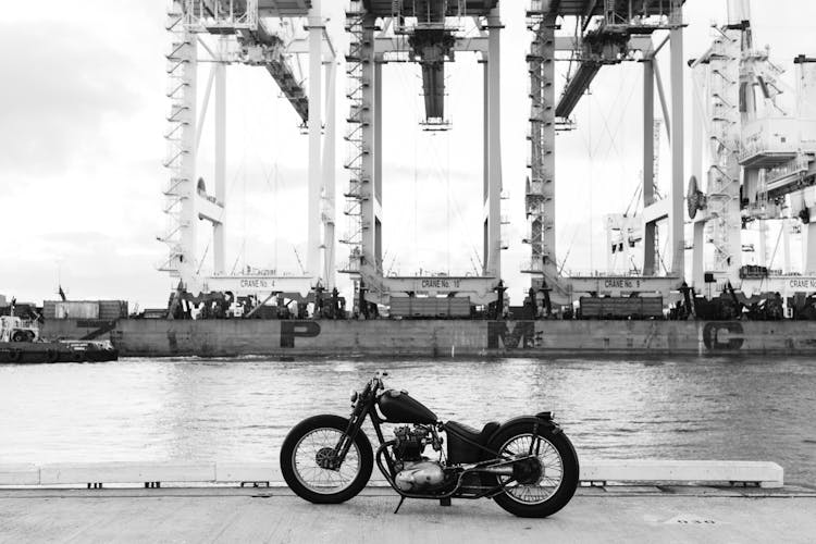 Vintage Motorbike On Embankment Of River