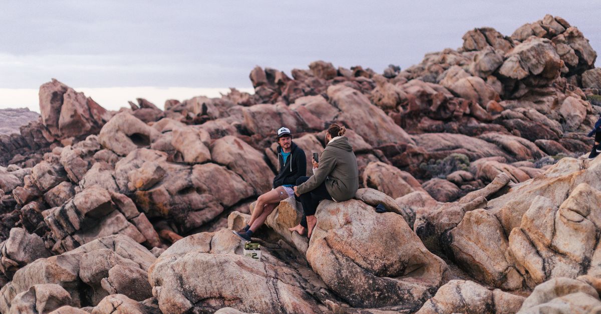 Resting On Rocks Unrecognizable couple of tourists resting on rocks · Free Stock Photo
