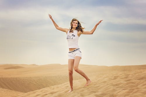 Free Woman Standing on Desert Sand Stock Photo