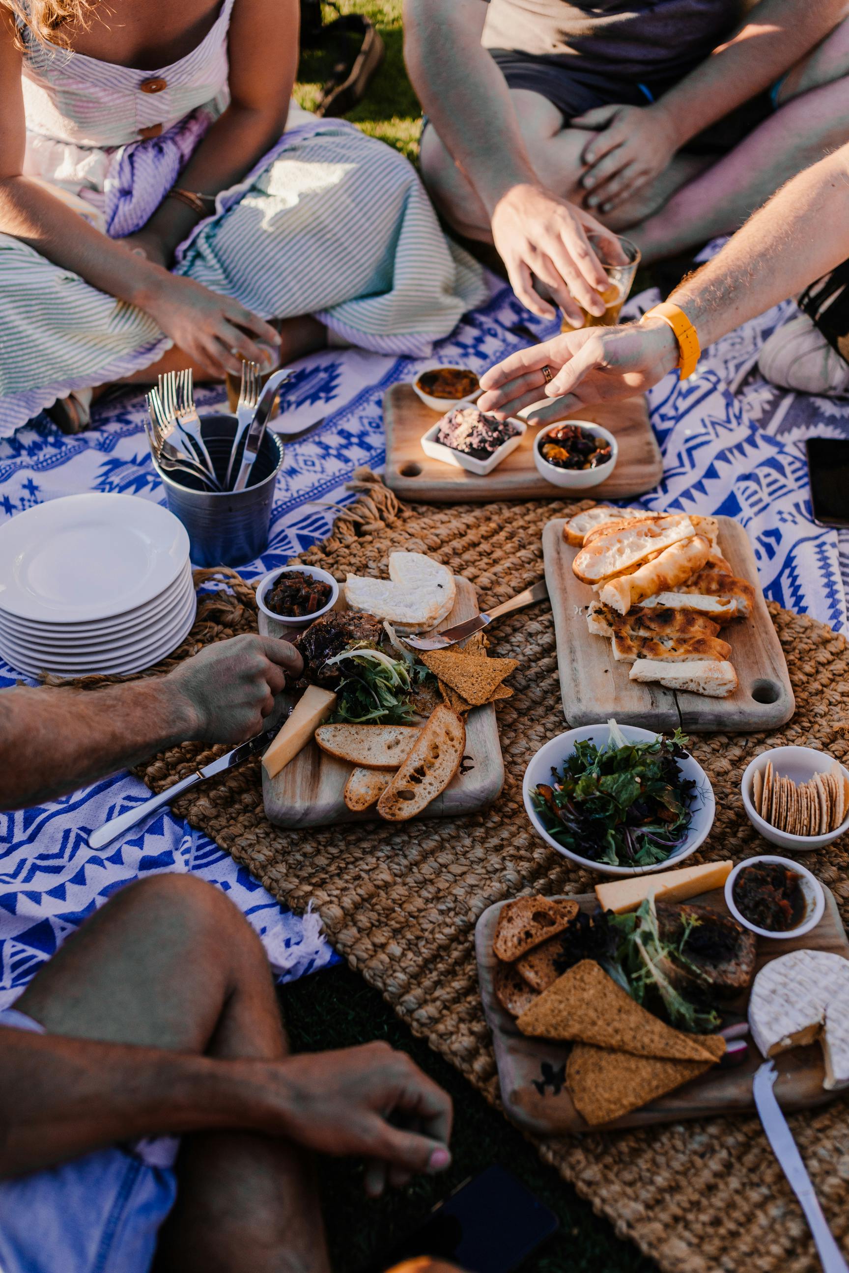 crop friends with assorted appetizers during summer picnic