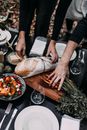 Crop couple serving delicious appetizers on table