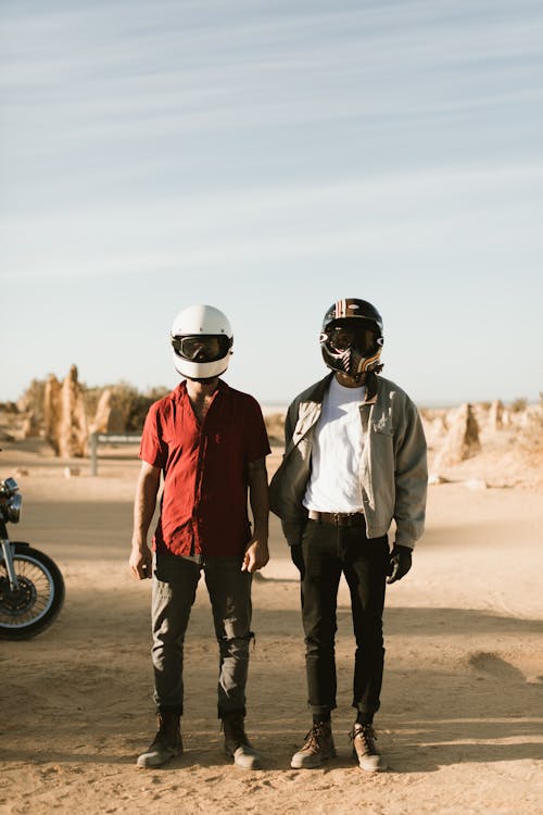 Unrecognizable male bikers in desert during summer trip