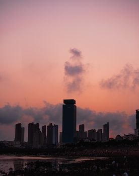 在摩天大楼的剪影映衬下，日落天空充满活力，捕捉着城市的宁静